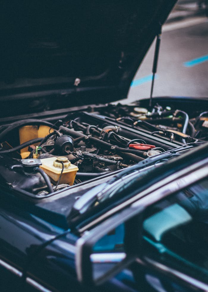 close-up-photo-of-vehicle-engine-1409999 Detailed view of an exposed car engine under maintenance in Barcelona.